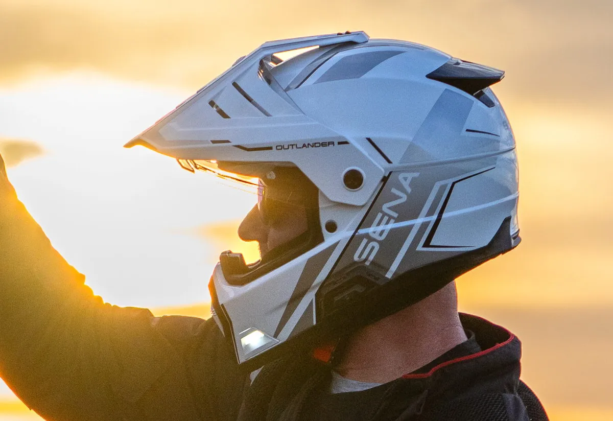 Un casque Sena Outlander blanc et un coucher de soleil