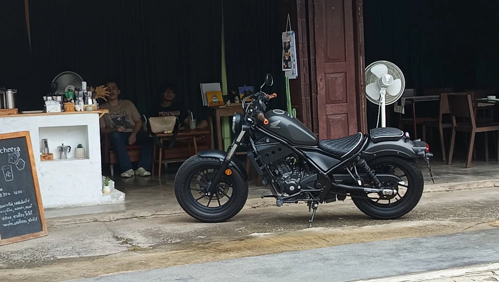 A Honda motorcycle in front of a store in Thailand