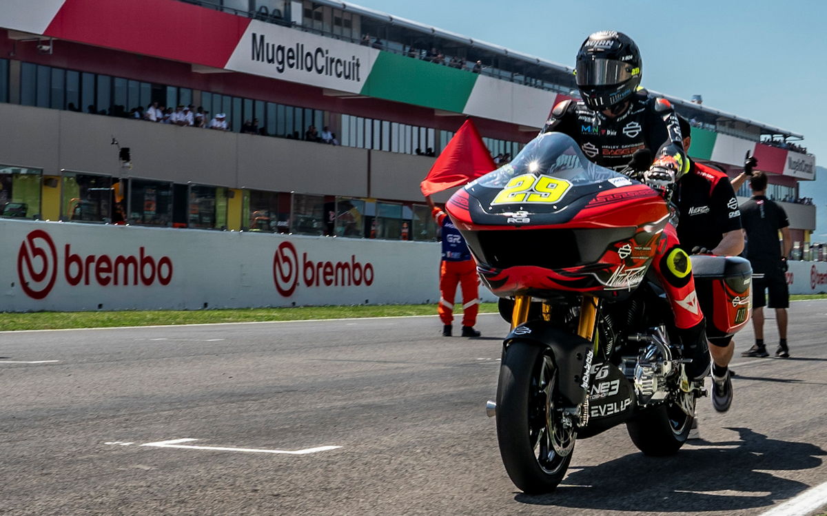 A Harley-Davidson bagger-style motorcycle at the starting line of a race
