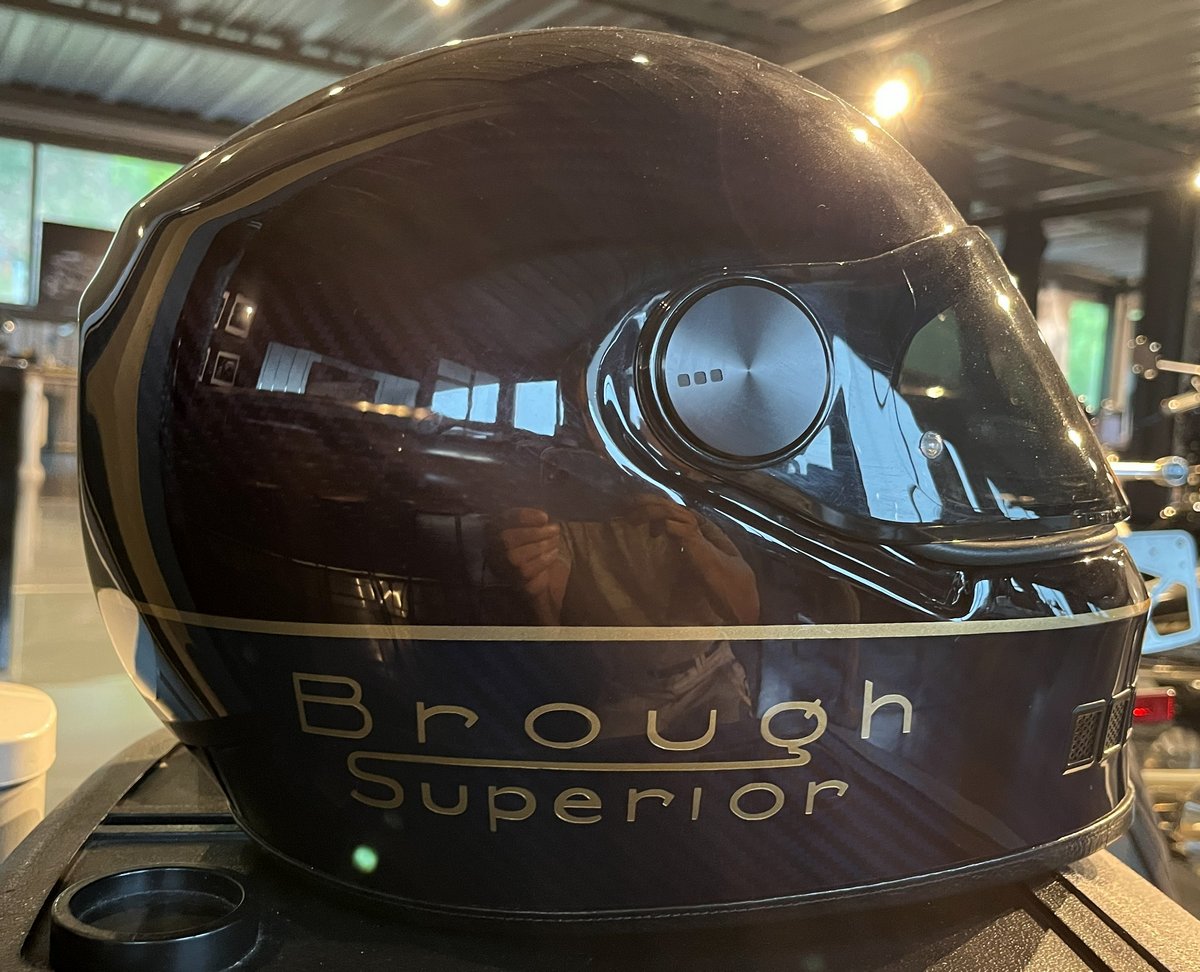 A black NACA helmet with the words "Brough Superior" on it